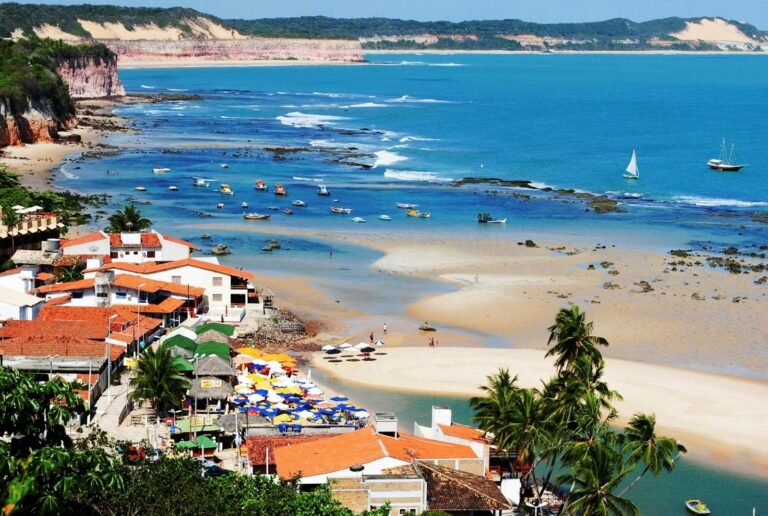 A breathtaking view of Praia de Pipa beach with vibrant seaside and blue ocean waters.